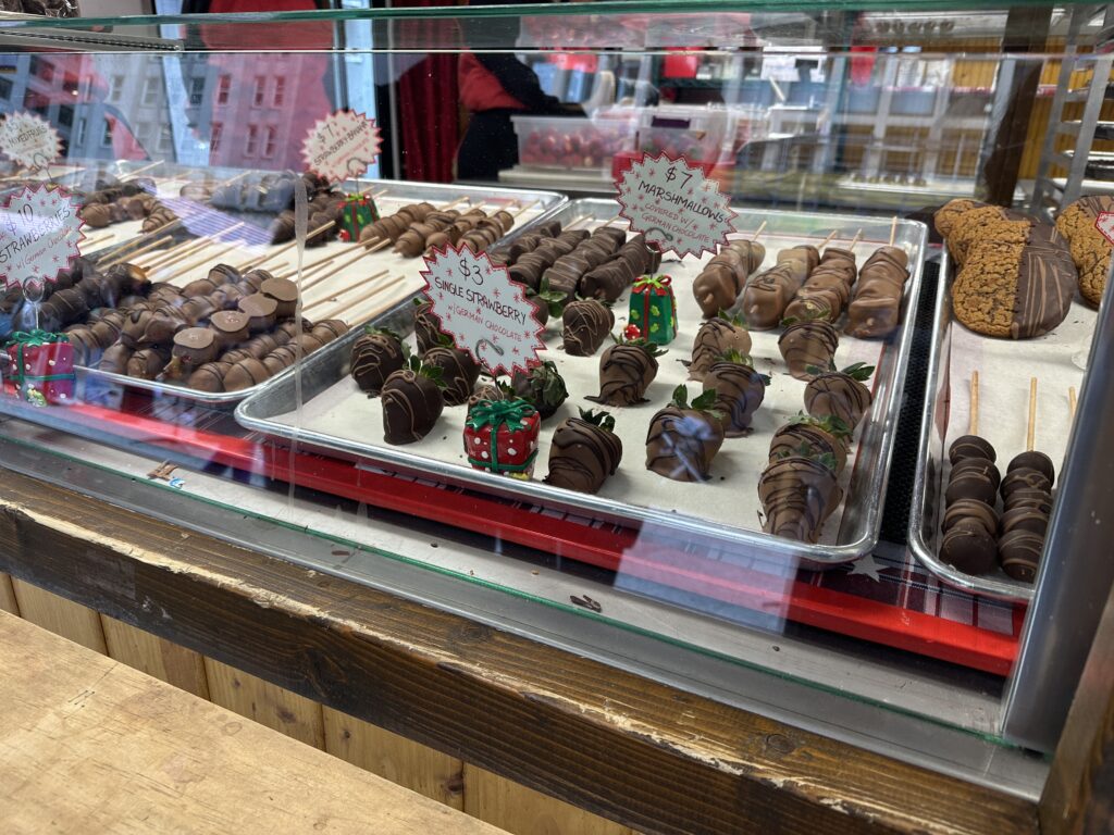 a trays of chocolate covered strawberries and cookies