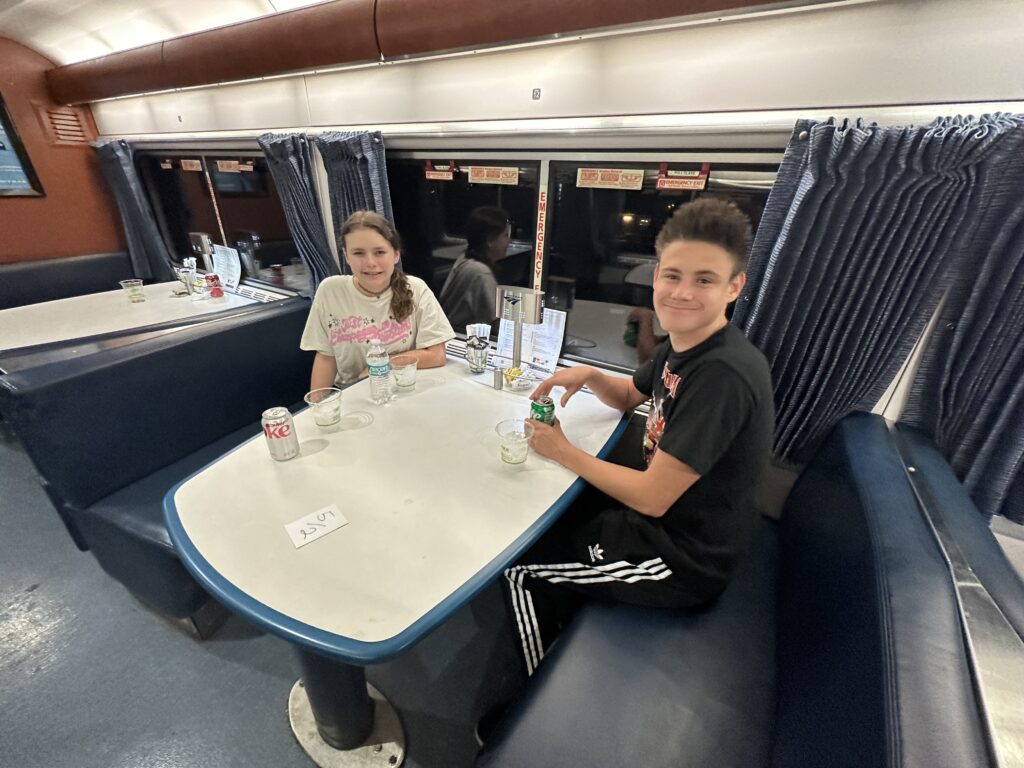 a boy and girl sitting at a table