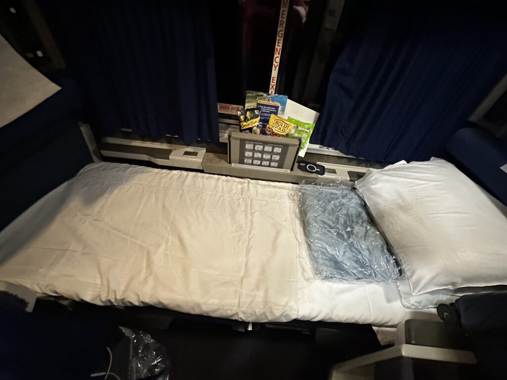 a bed with a pillow and a telephone