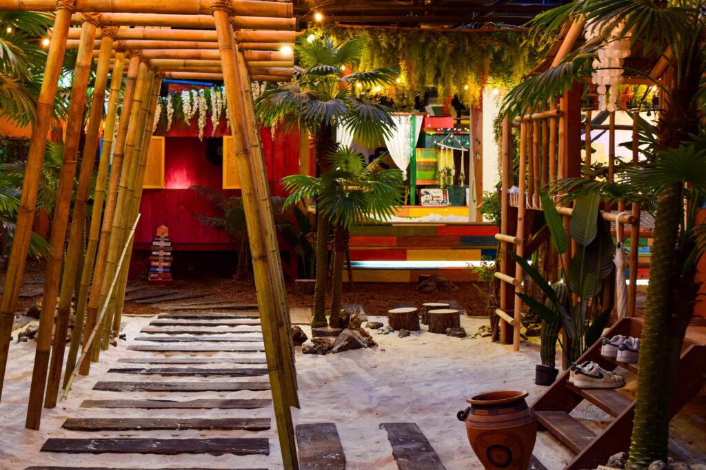 a wooden structure with a ladder and a potted plant