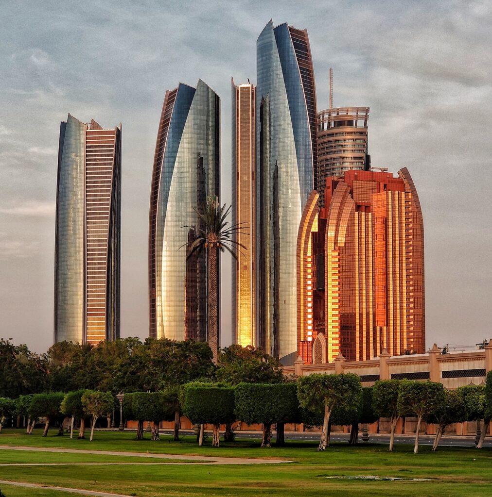 a group of tall buildings with trees in front of them