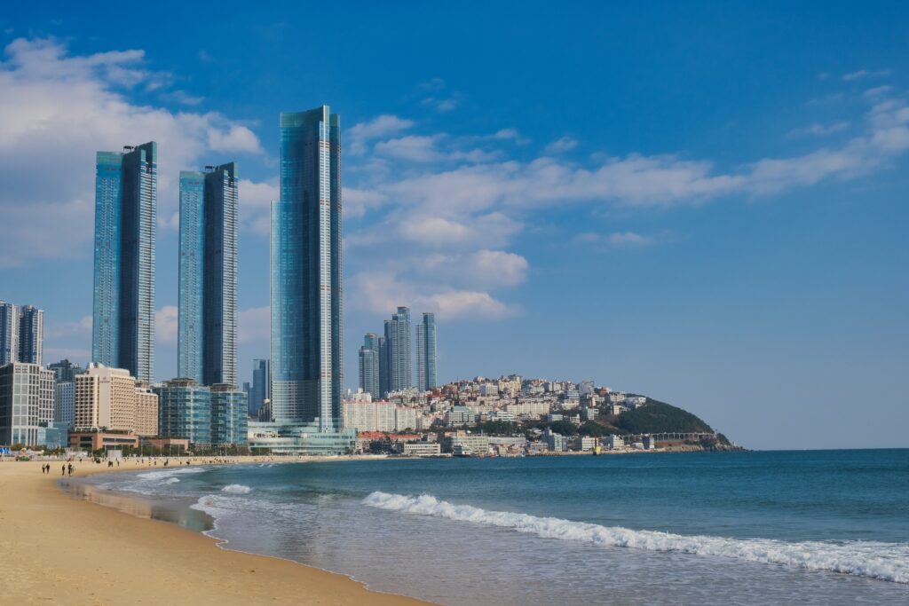 a beach with a city and water