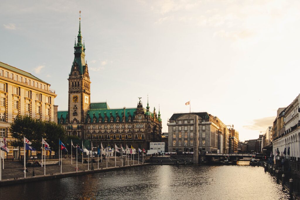 a building with a clock tower and a river