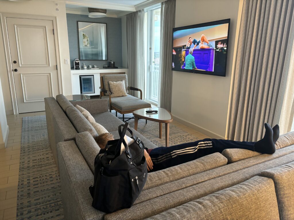 a person lying on a couch in a living room