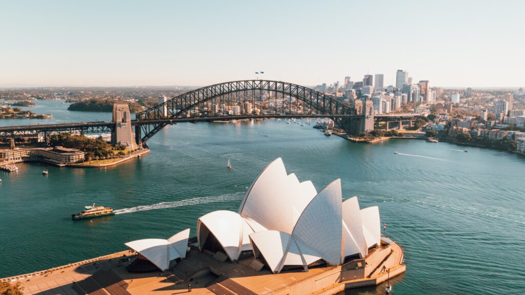 Sydney Harbour Bridge over water with a building and a city