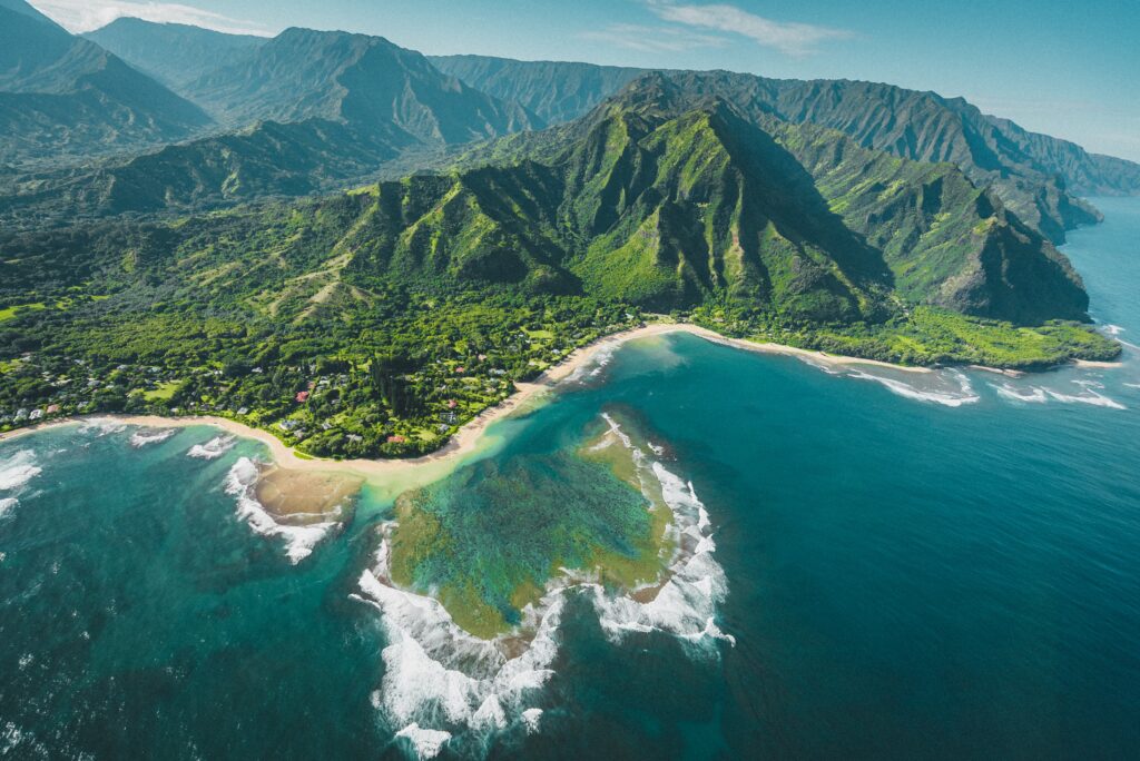 a aerial view of a beach and mountains