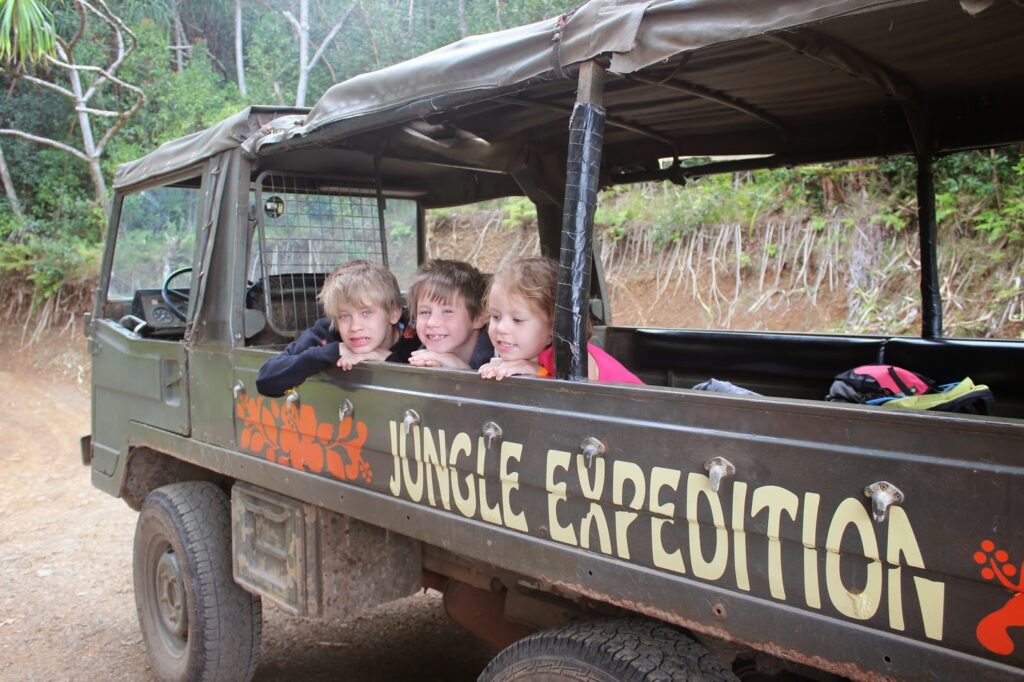 a group of kids in a jeep