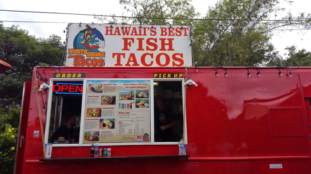 a food truck with a sign on the side