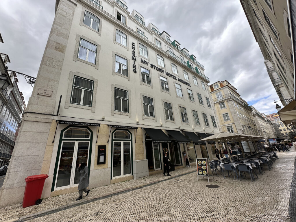 a building with many windows and tables outside