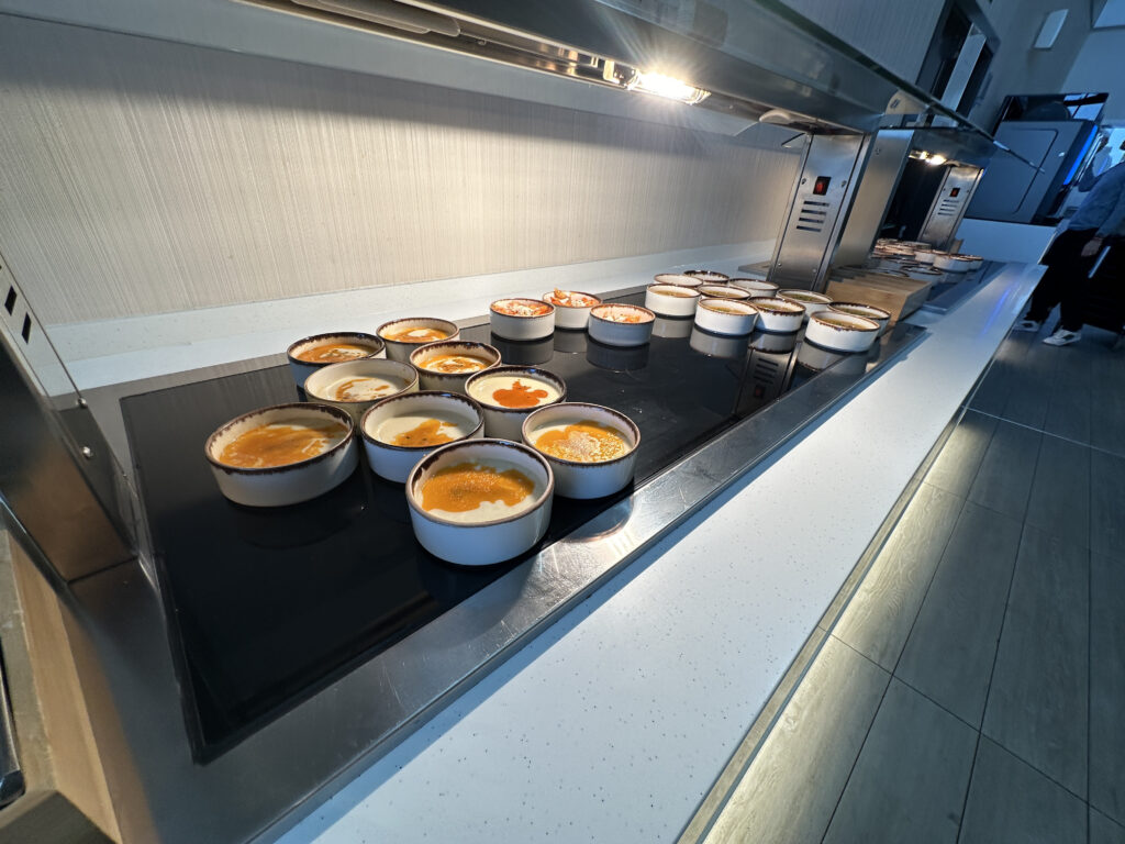 a group of bowls of food on a stove