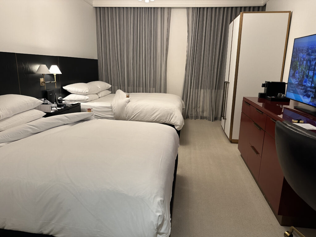 a room with two beds and a dresser