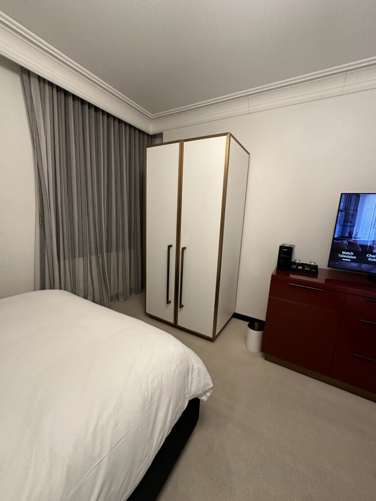 a bedroom with a bed and a tv