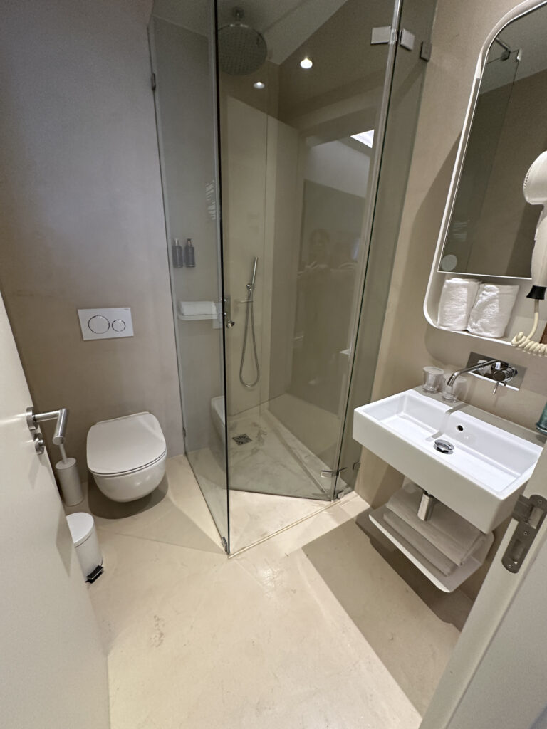 a bathroom with a glass shower and sink