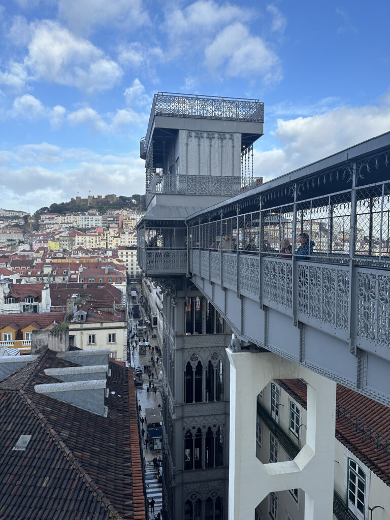 a building with a bridge and a city in the background