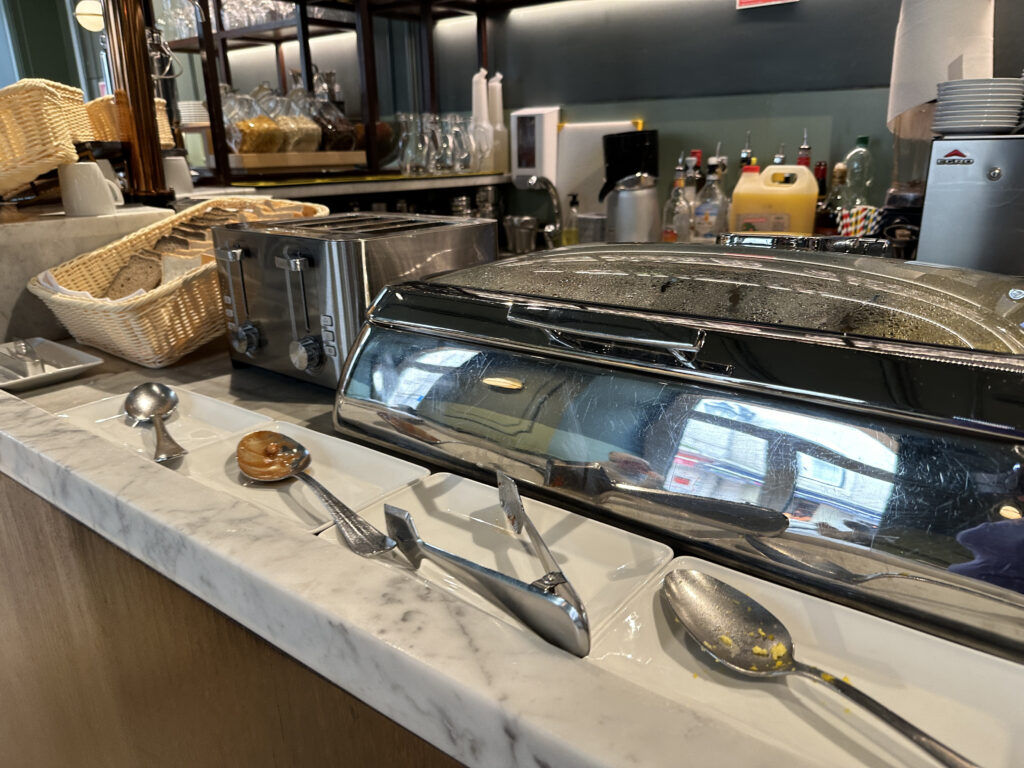 a toaster and spoons on a counter