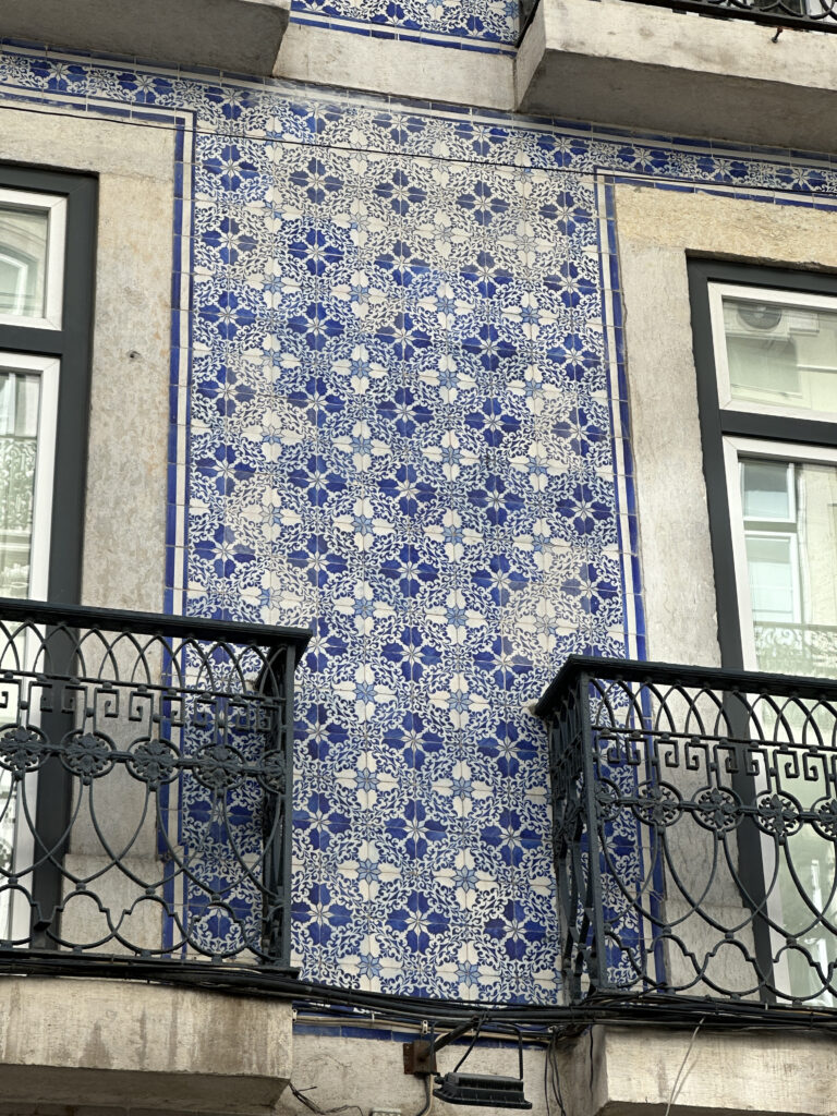 a balcony with a tile wall