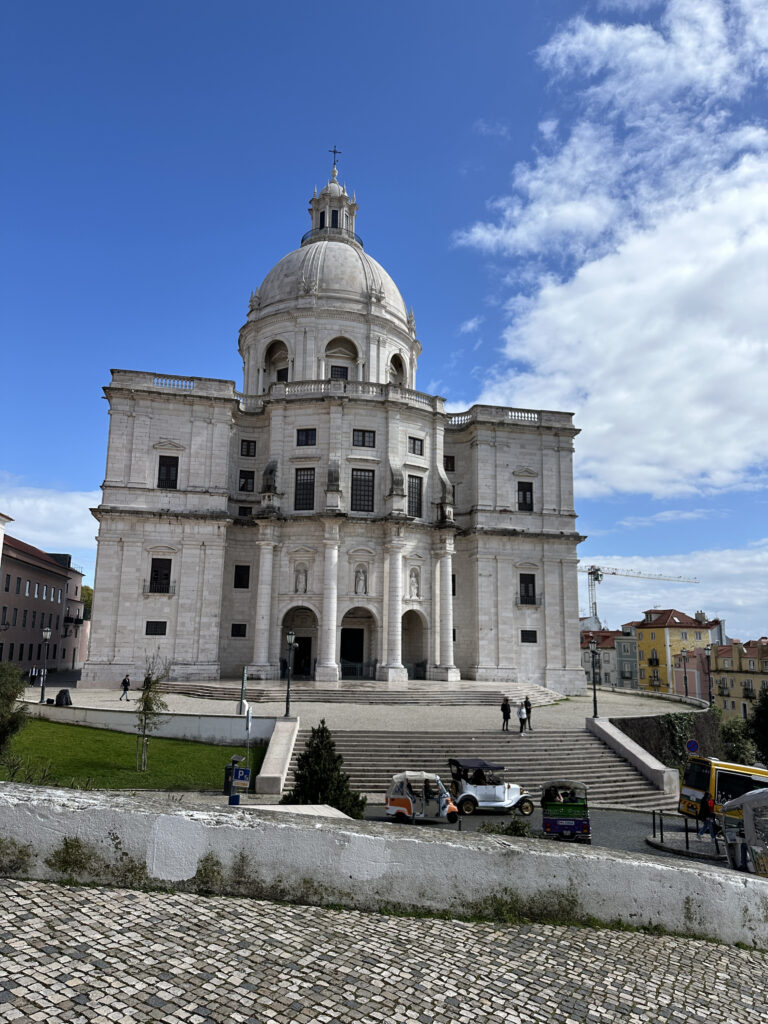 a large white building with a dome and stairs