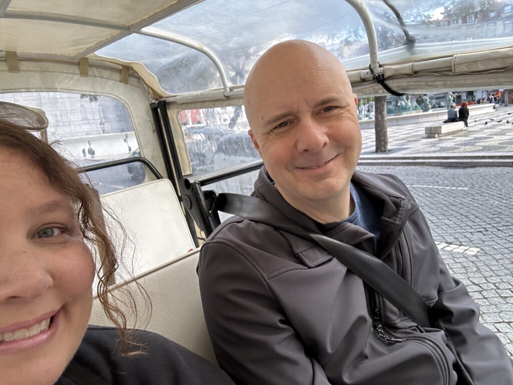 a man and woman sitting in a vehicle