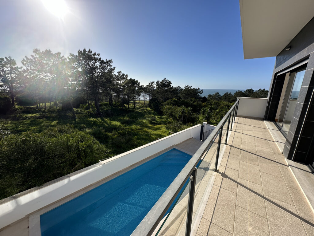 a pool on a deck overlooking a body of water