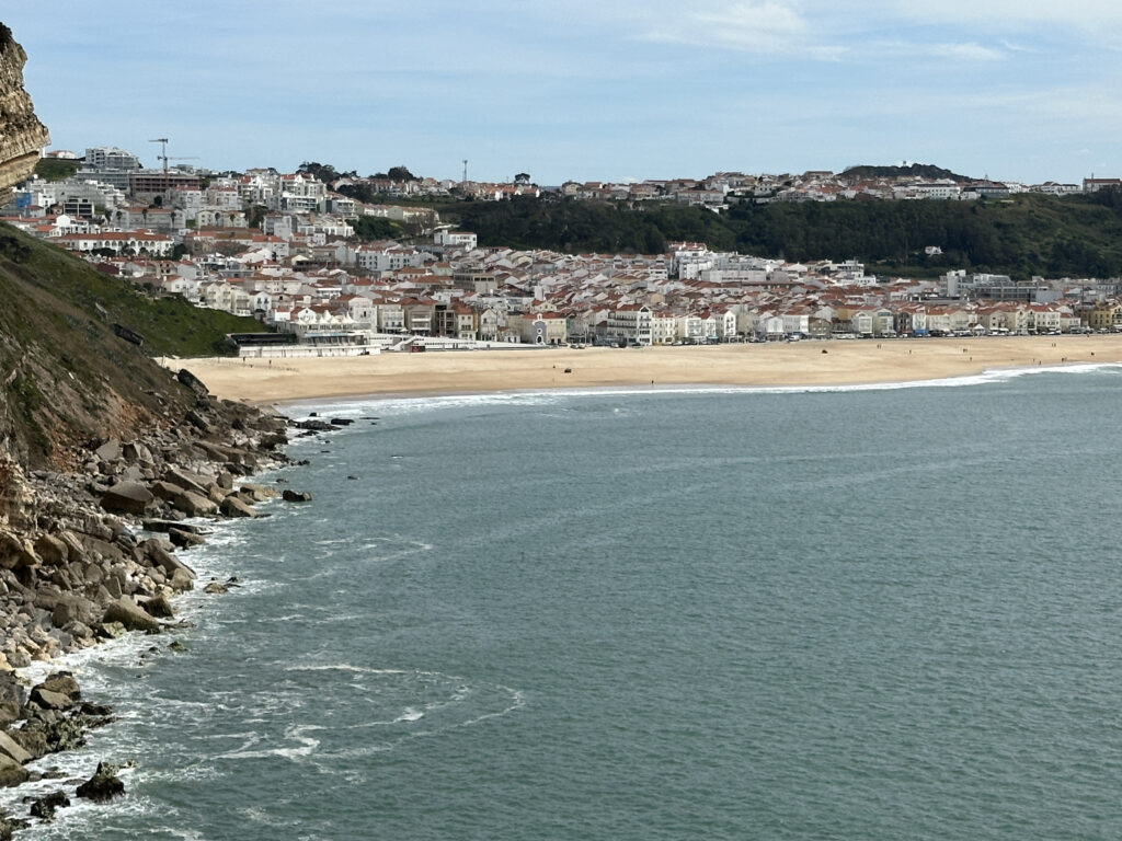 a beach with buildings and a body of water