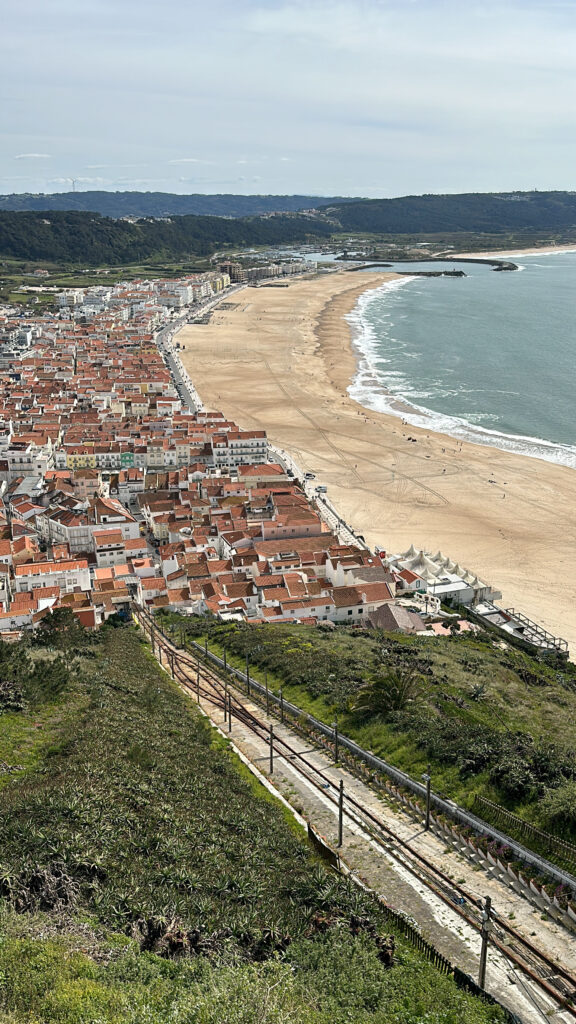 a beach with buildings and a body of water