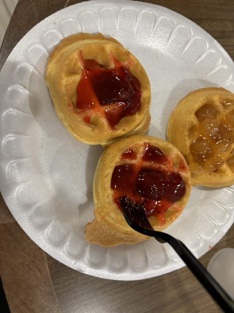 a plate of waffles with jam on top