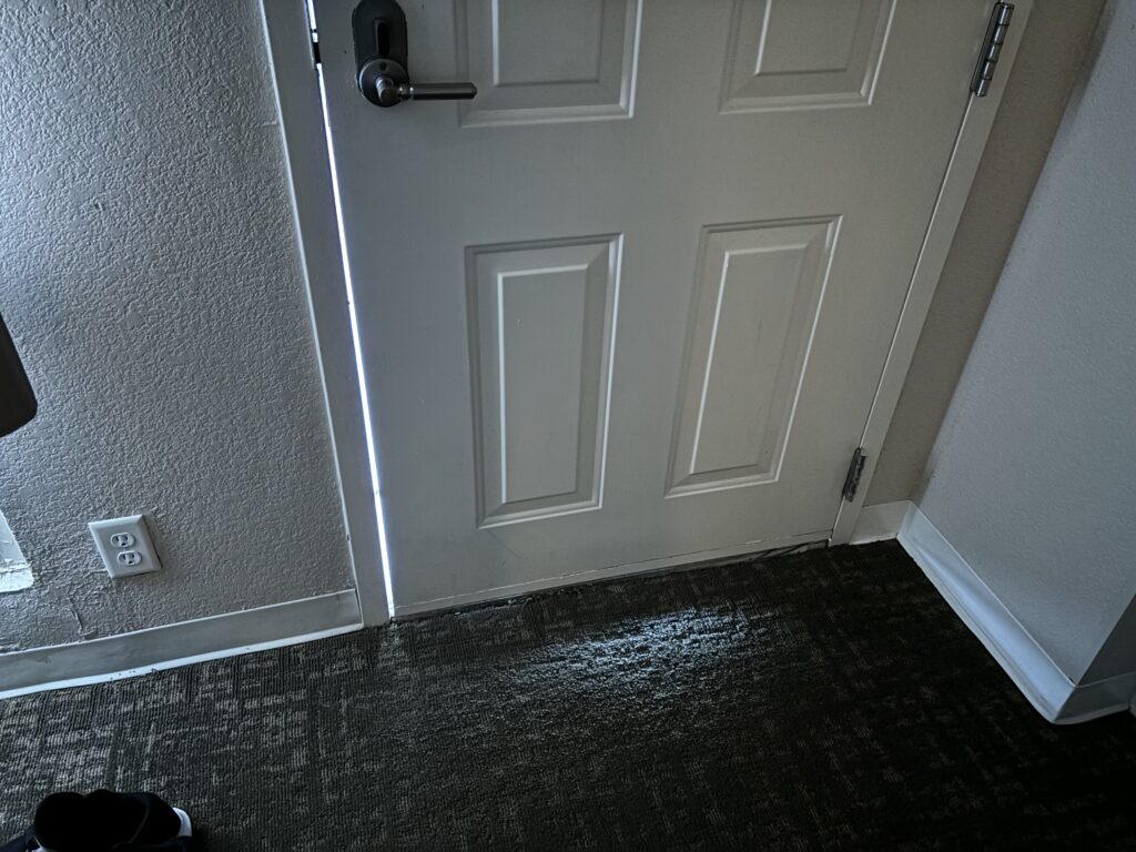 a white door with a light coming out of it