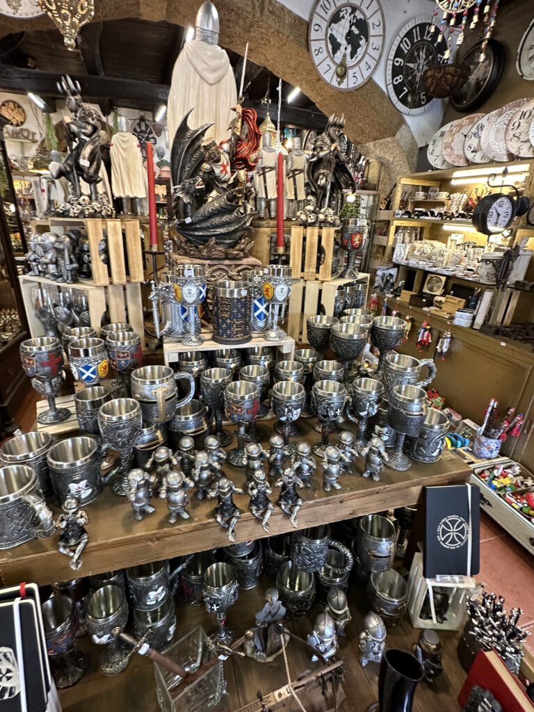 a display of metal cups and mugs