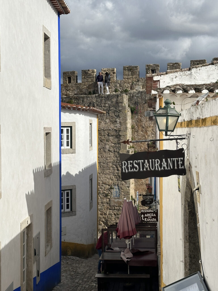 a street with a sign and a wall