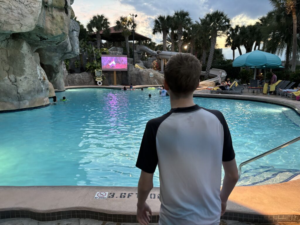 a man standing in front of a pool