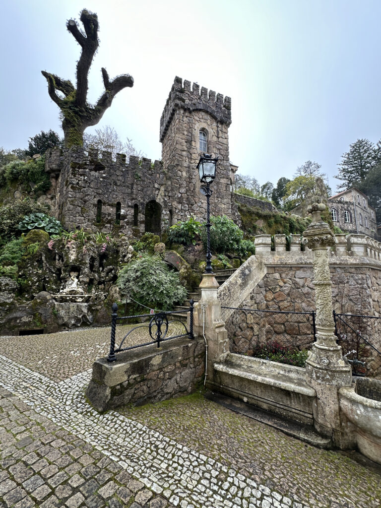 a stone castle with a stone staircase and a stone wall