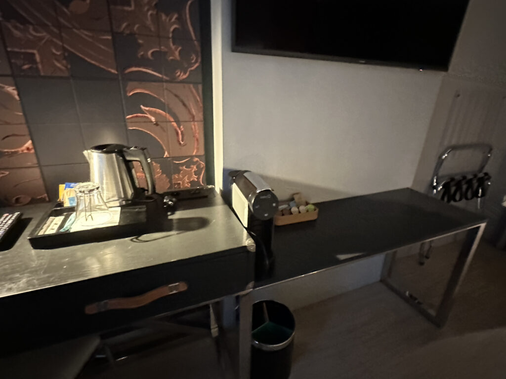 a table with a coffee maker and a television