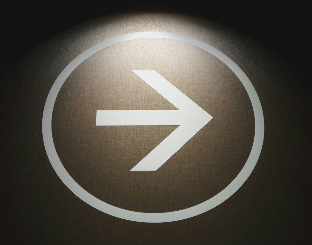a white arrow in a circle