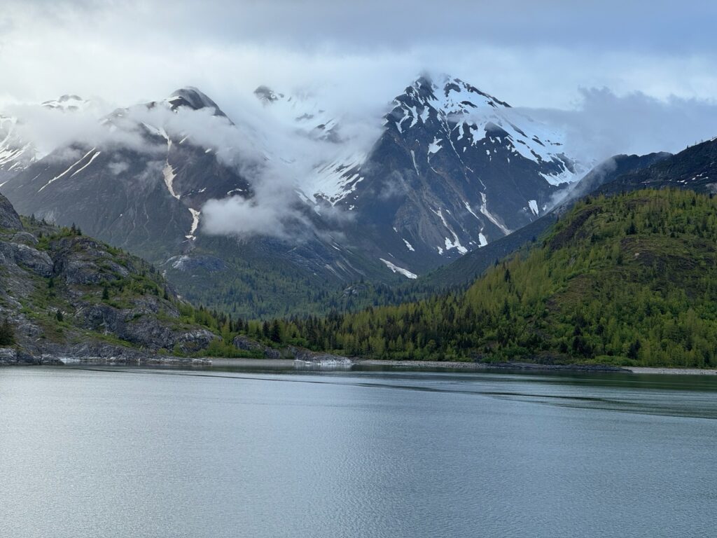 a lake with mountains and clouds