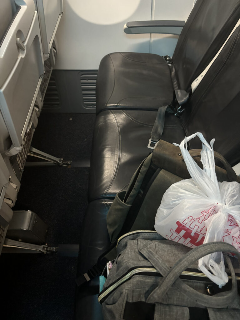 a seat of a vehicle with a bag and a bag on it
