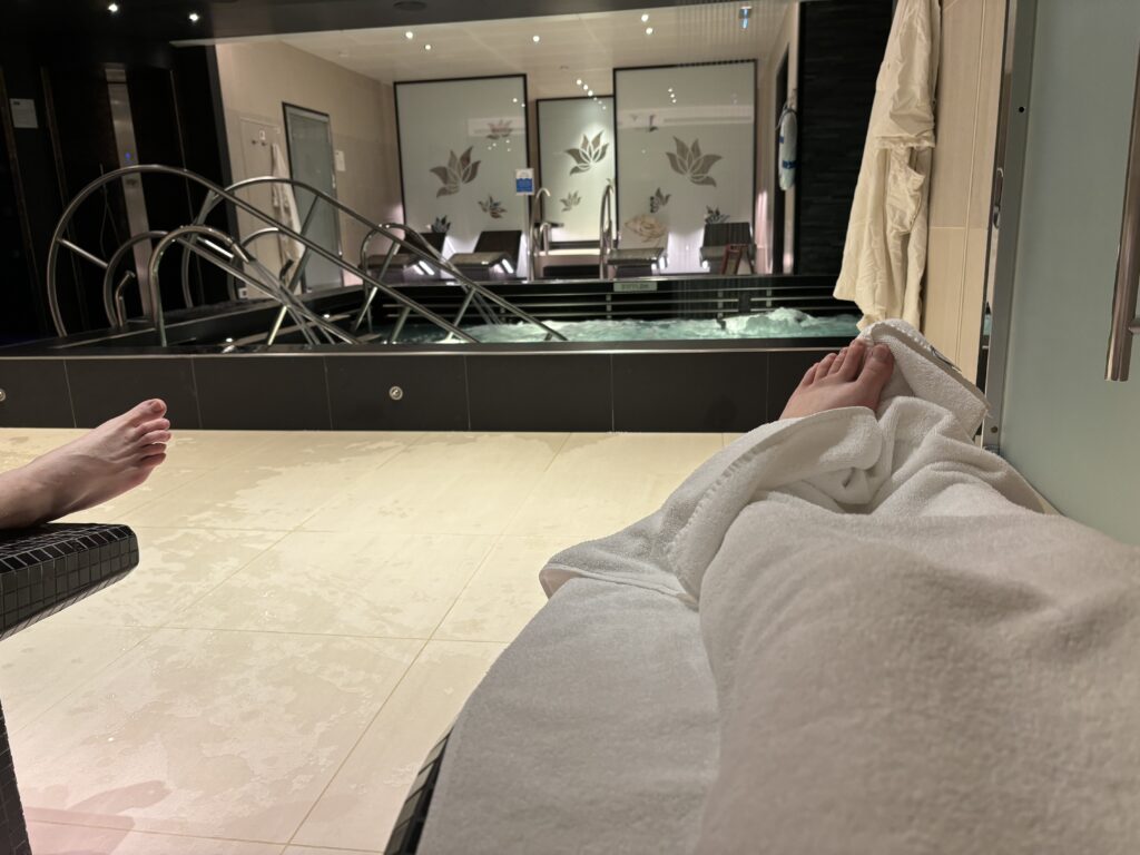 a person's feet on a towel in a spa room
