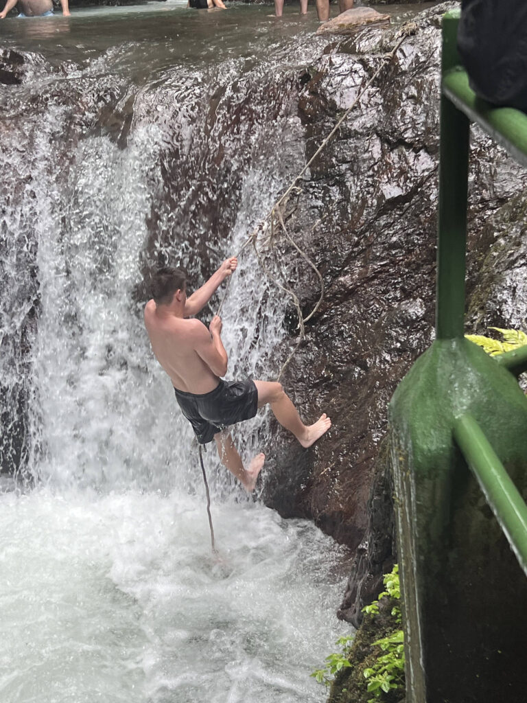 a man climbing a waterfall