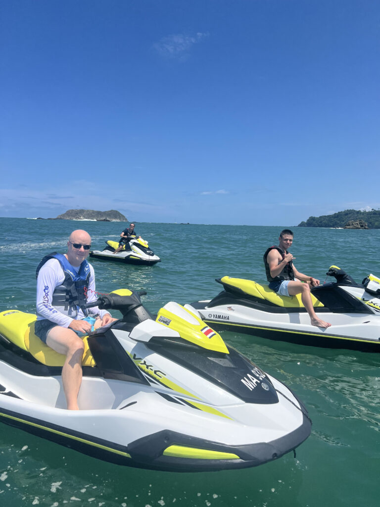 a group of men on jet skis in the water