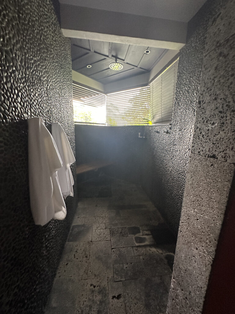 a bathroom with a bench and towels
