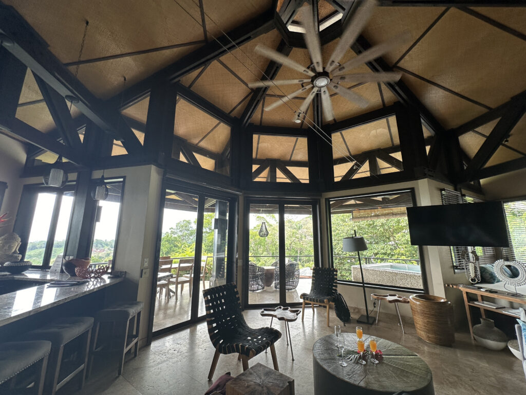 a room with a ceiling fan and chairs