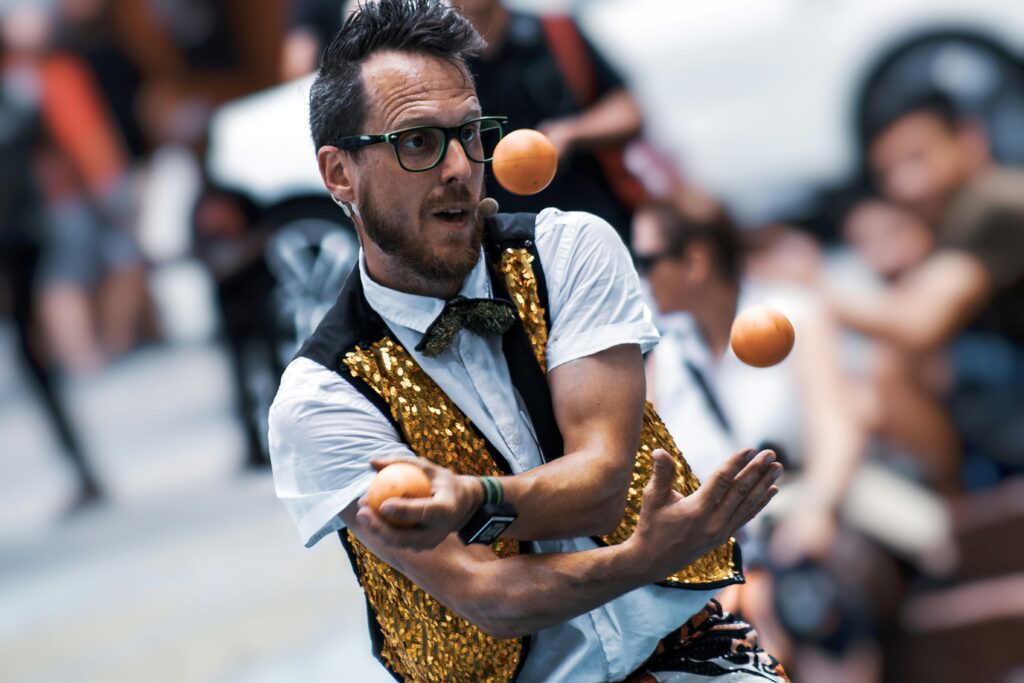 a man juggling oranges