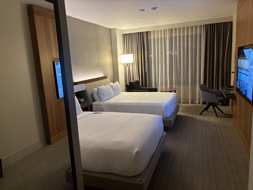 a room with two beds and a chair
