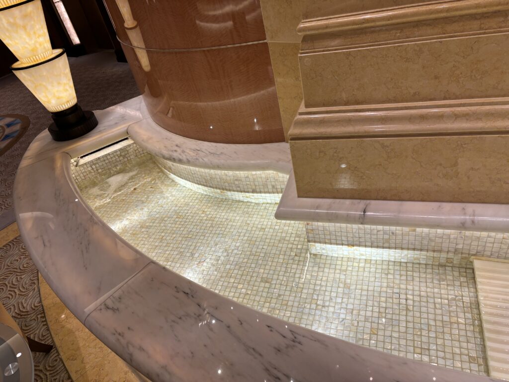 a marble fountain with a light on the side
