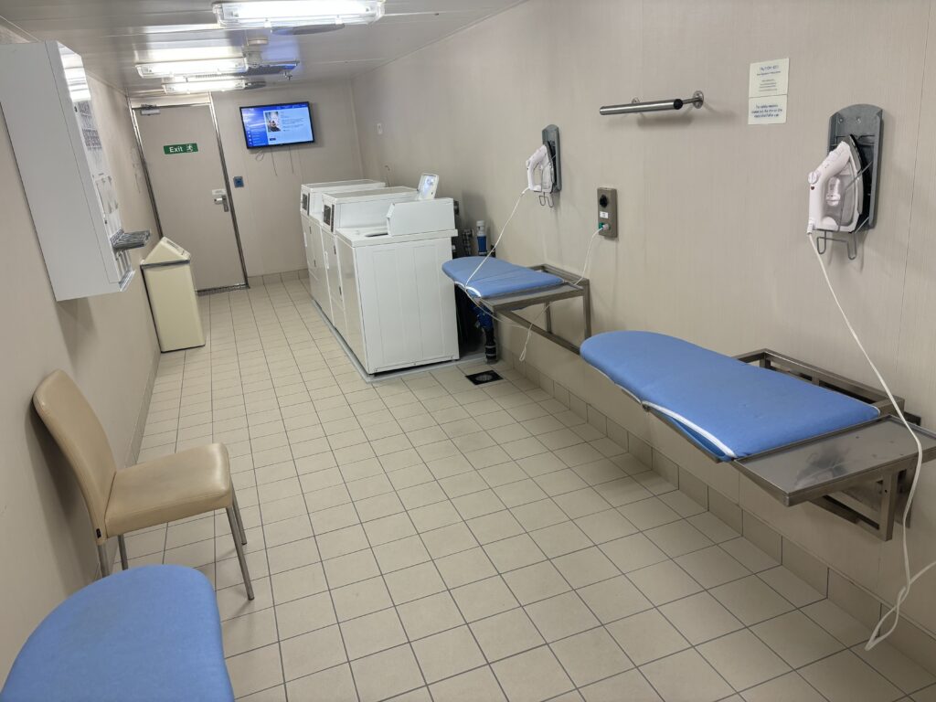a room with blue beds and white dryers