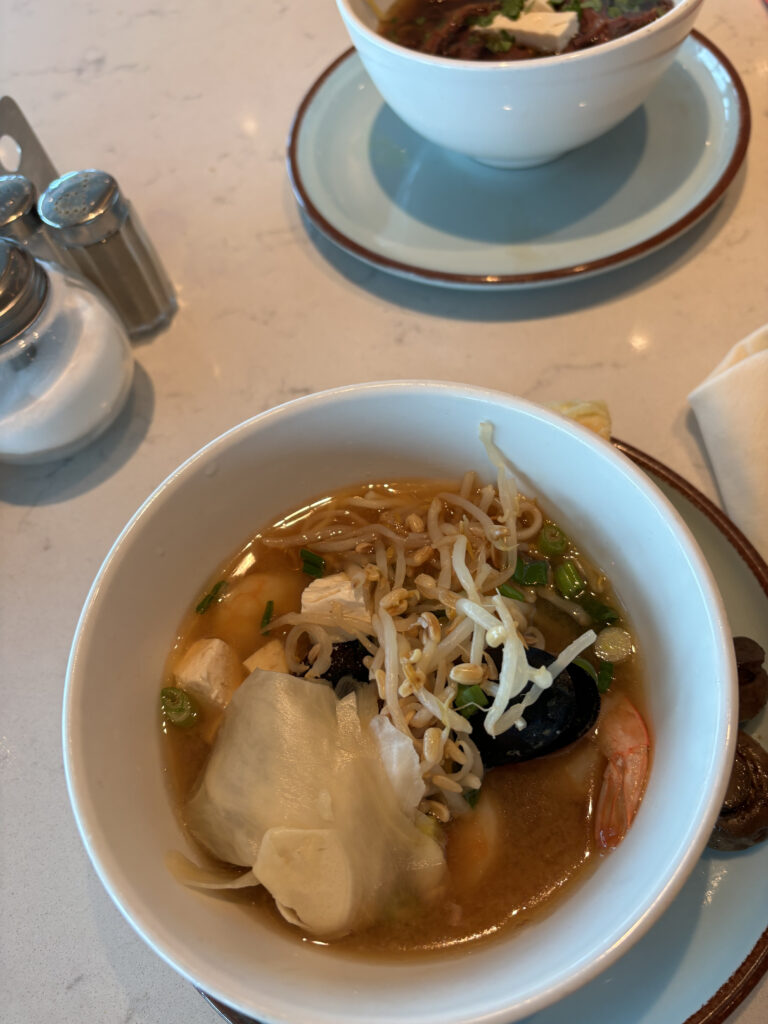 a bowl of soup with noodles and vegetables