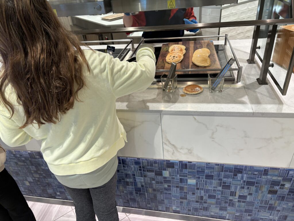 a girl cooking food on a grill