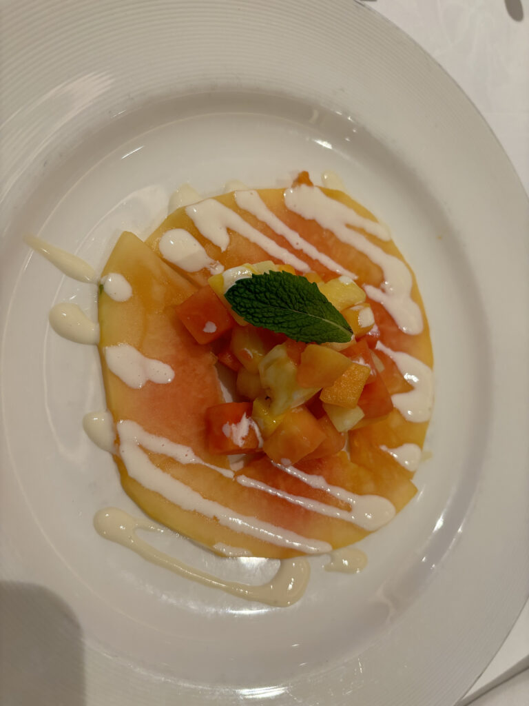 a plate of fruit and sauce