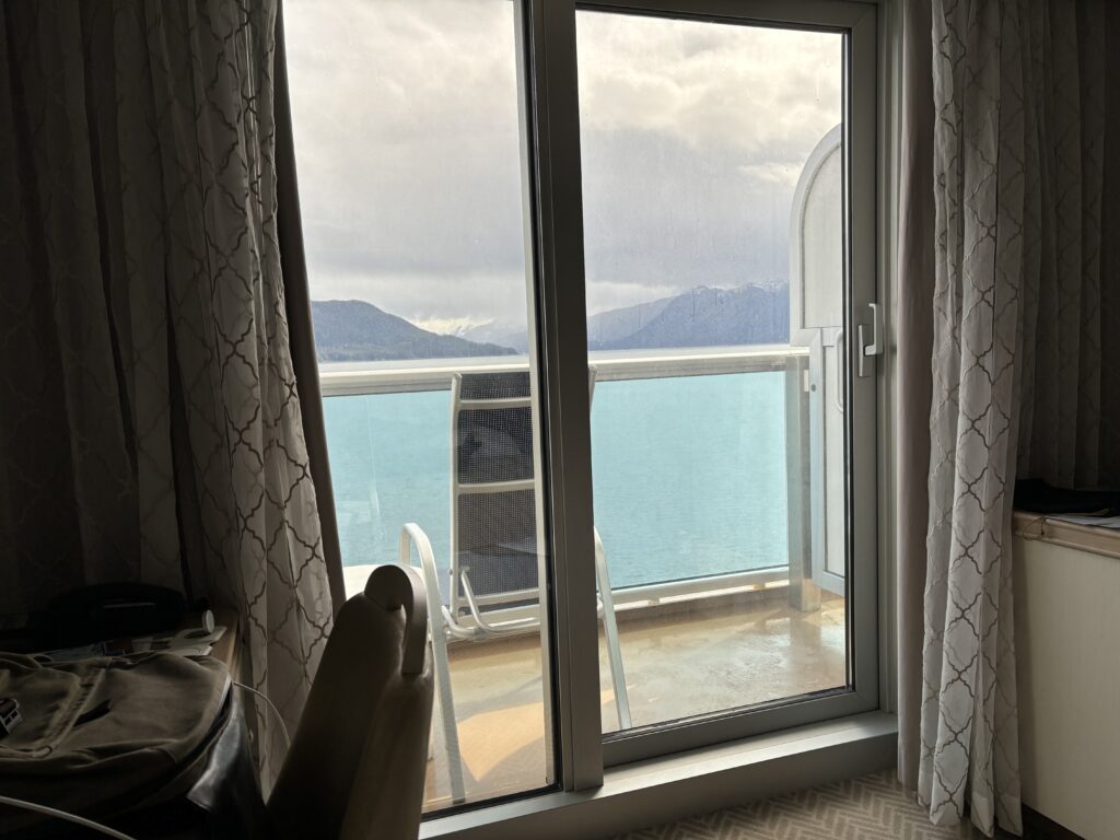 a sliding glass door with a view of a lake and mountains