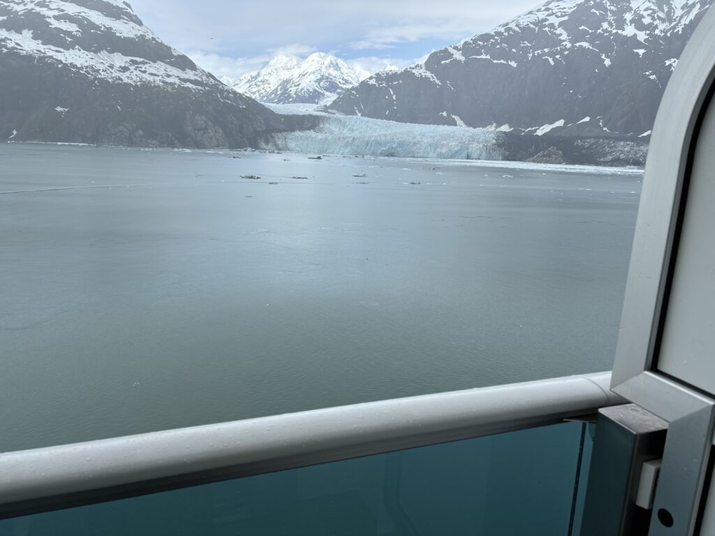a view of a glacier and mountains from a balcony