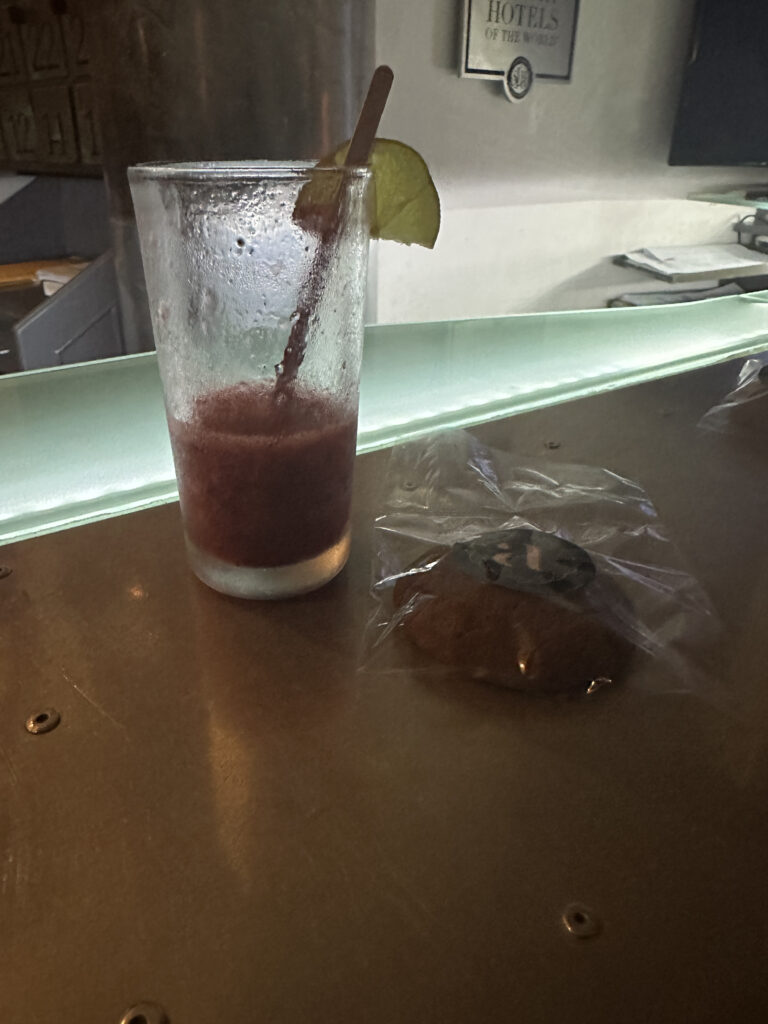 a glass with a straw and a lime slice on a table
